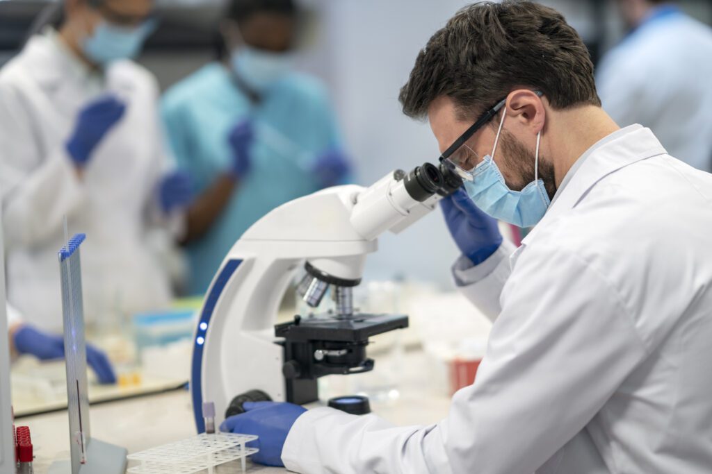 Laboratorio analisi microbiologiche Cagliari: foto di un ricercatore al microscopio